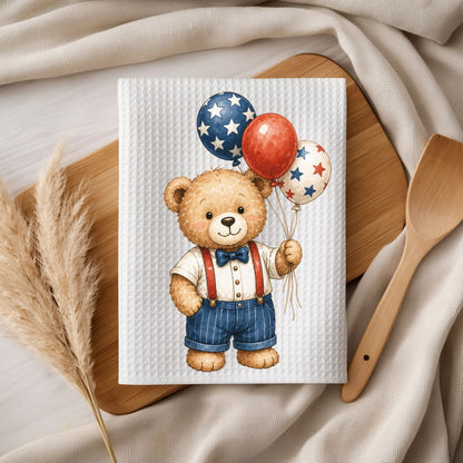 White microfiber tea towel with a vintage-style teddy bear holding red, white, and blue star balloons.