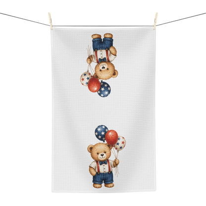 White microfiber tea towel with a vintage-style teddy bear holding red, white, and blue star balloons.