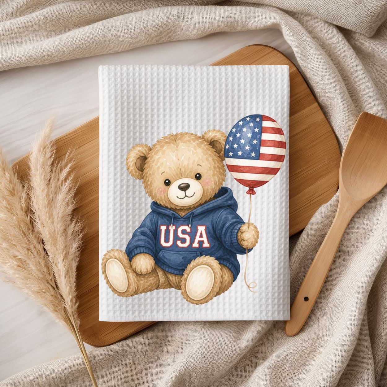 White microfiber tea towel with a watercolor teddy bear in a USA hoodie holding an American flag balloon.
