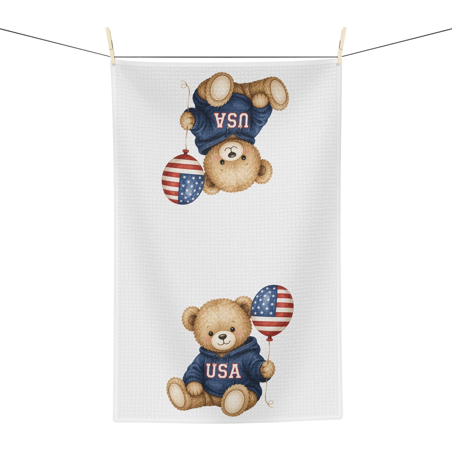 White microfiber tea towel with two watercolor teddy bears in USA sweatshirts holding flag balloons.
