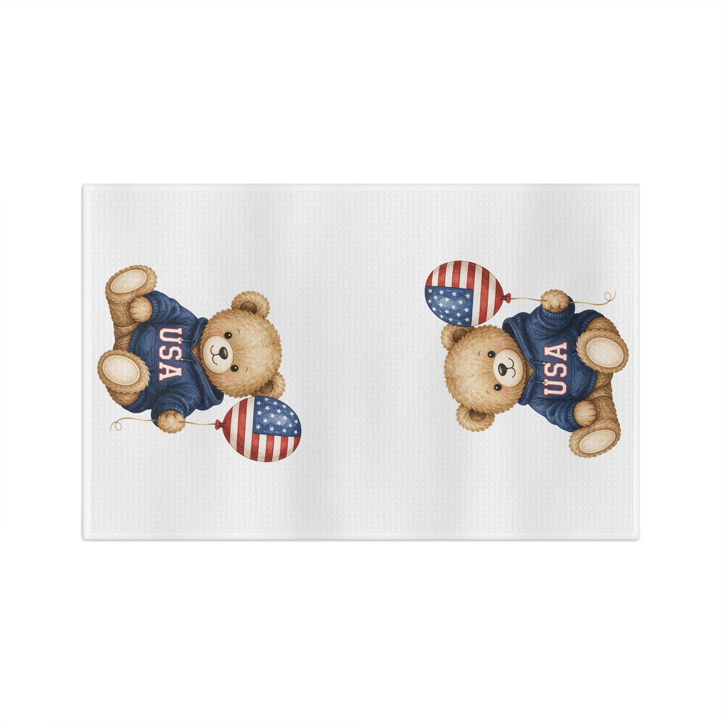 White microfiber tea towel with two watercolor-style teddy bears in USA sweatshirts holding flag balloons.