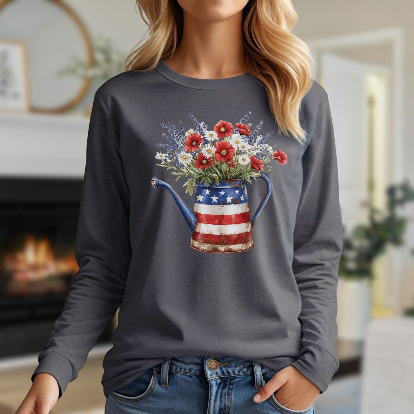 Woman in a charcoal long-sleeve tee with a patriotic watering can holding red, white, and blue wildflowers.