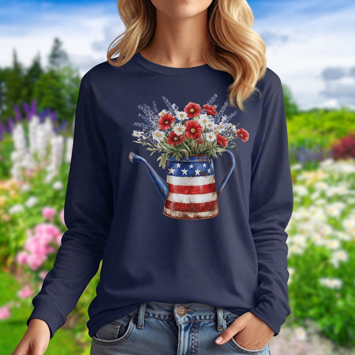 Navy long sleeve tee with a patriotic watering can holding red, white, and blue wildflowers.
