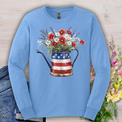 Carolina Blue long sleeve tee with a patriotic watering can holding red, white, and blue wildflowers.