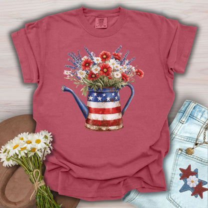 Crimson S t-shirt with a rustic patriotic watering can overflowing with lavender, daisies, and red poppies.