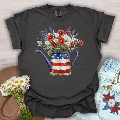Pepper S t-shirt with patriotic watering can overflowing with lavender, daisies, and poppies.