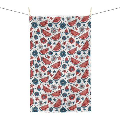 Microfiber tea towel with watercolor watermelon slices, red flowers, and blue floral motifs on a white background.