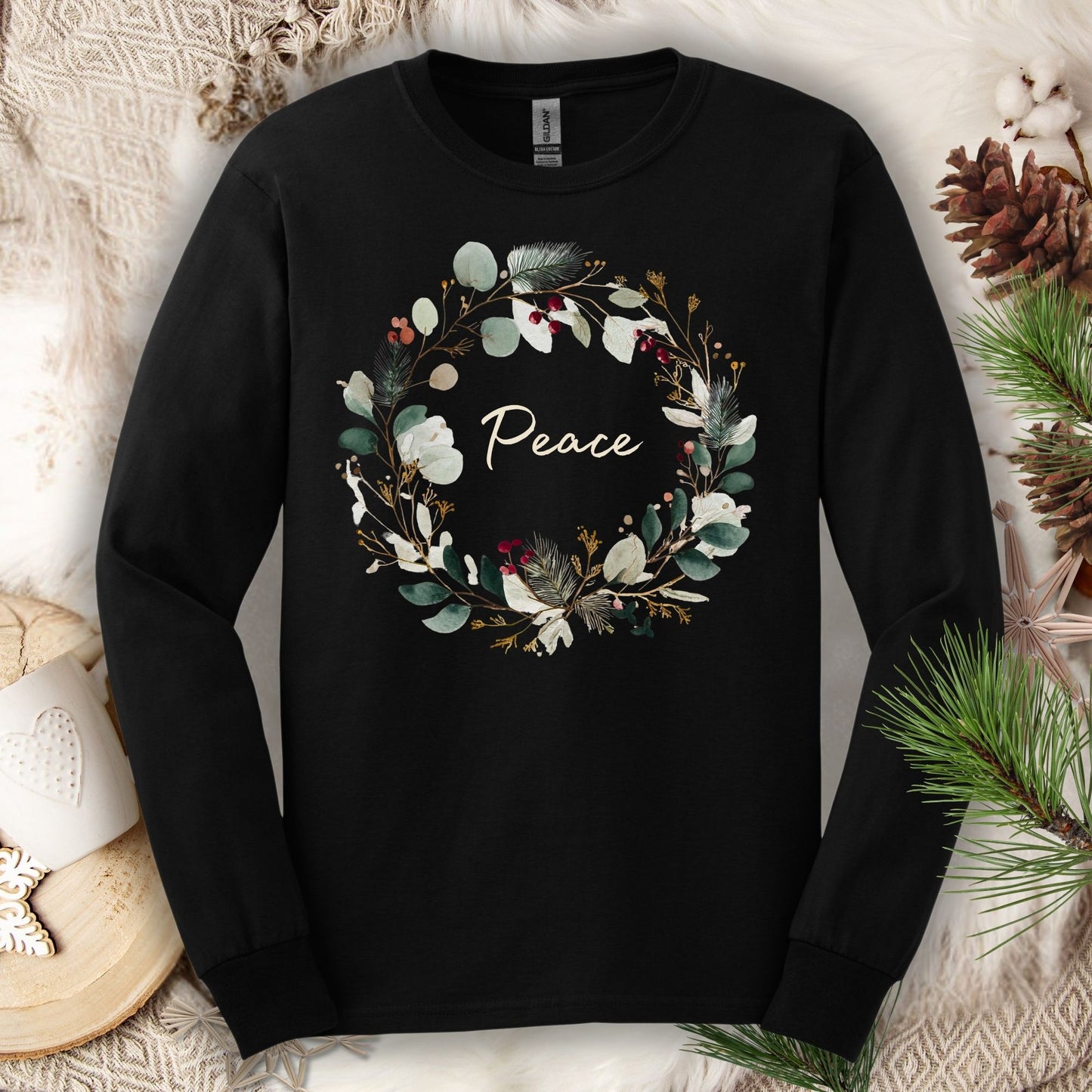Black Gildan long sleeve tee with a watercolor "Peace" Christmas wreath design.