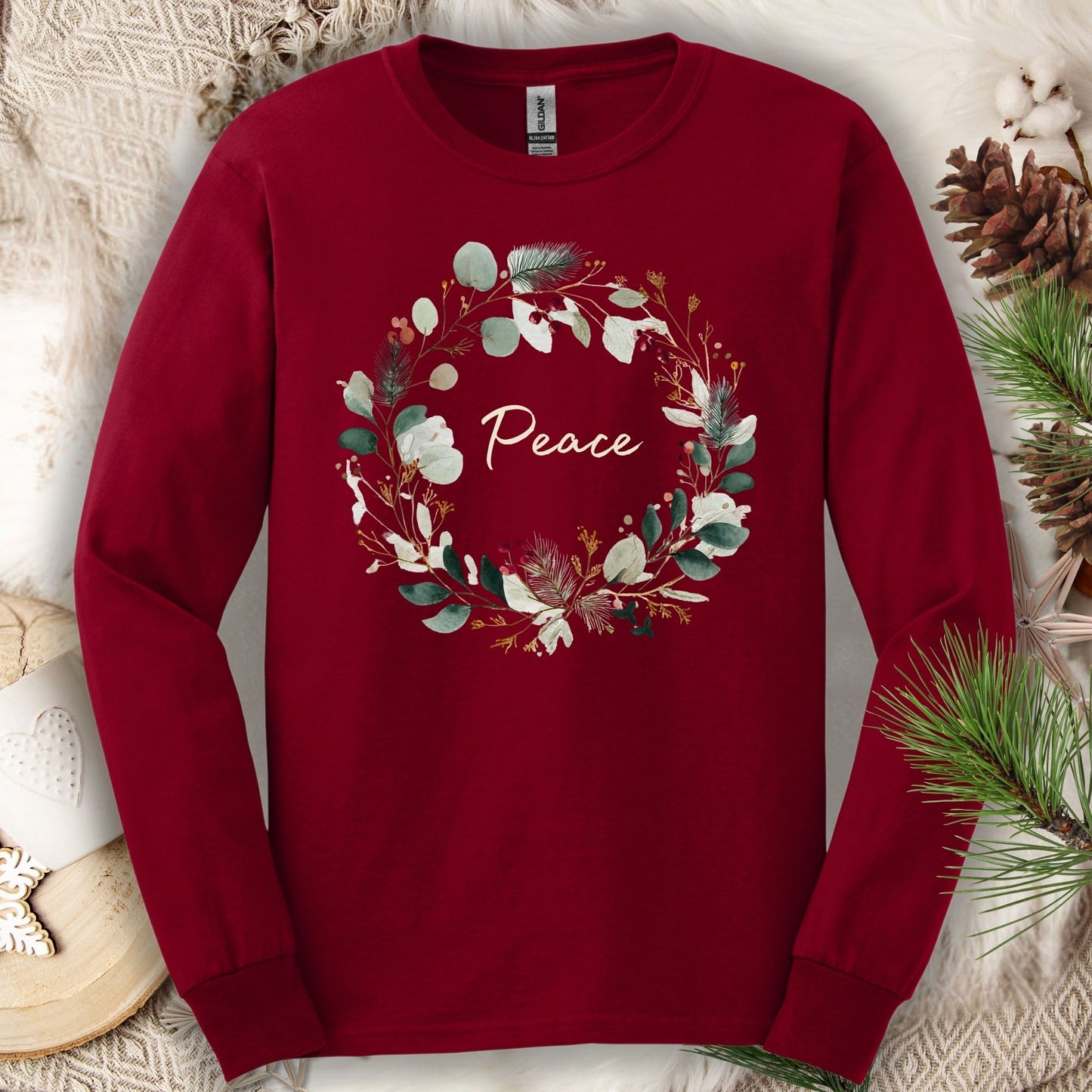 Cardinal Red Gildan long sleeve tee with a watercolor "Peace" Christmas wreath design.