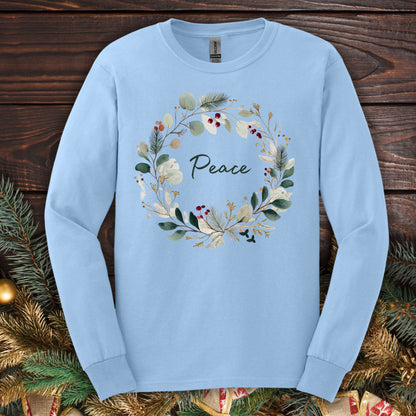 Light blue Gildan long sleeve tee with a watercolor "Peace" Christmas wreath design.