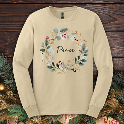 Sand Gildan long sleeve tee with a watercolor "Peace" Christmas wreath design.