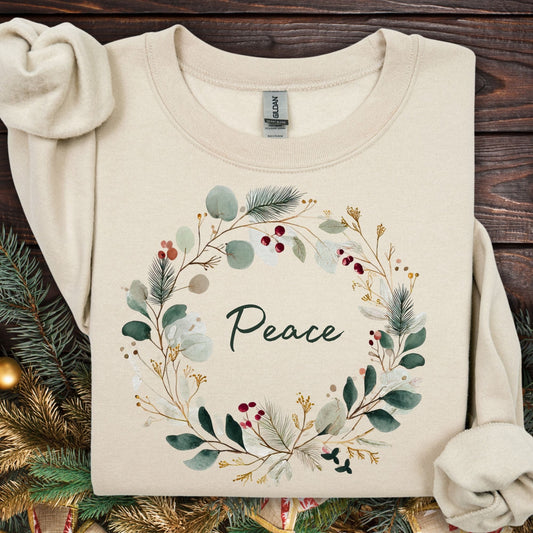 Sand heavyweight cotton sweatshirt with a watercolor "Peace" Christmas wreath design.