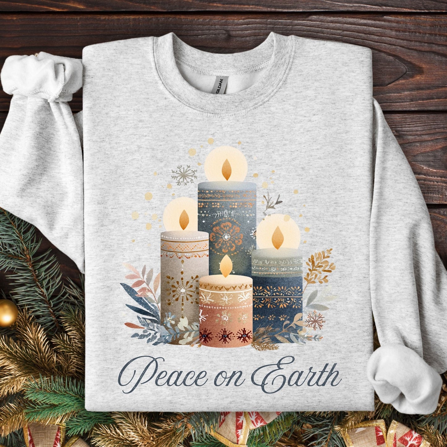Ash gray sweatshirt with Nordic-style advent candles, winter foliage, and "Peace on Earth" in muted tones.