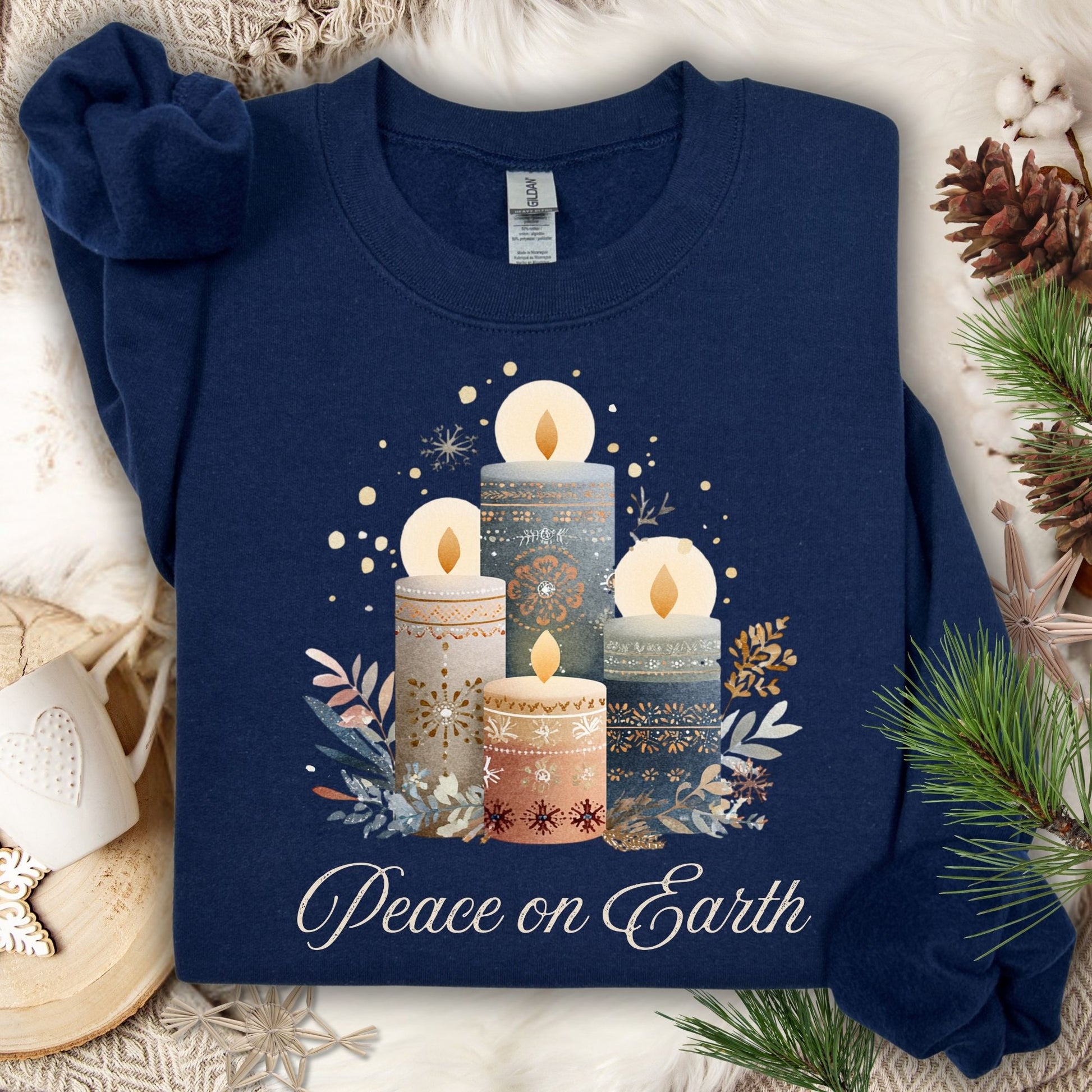 Navy Gildan sweatshirt with Nordic advent candles, winter foliage, and "Peace on Earth" in muted tones.