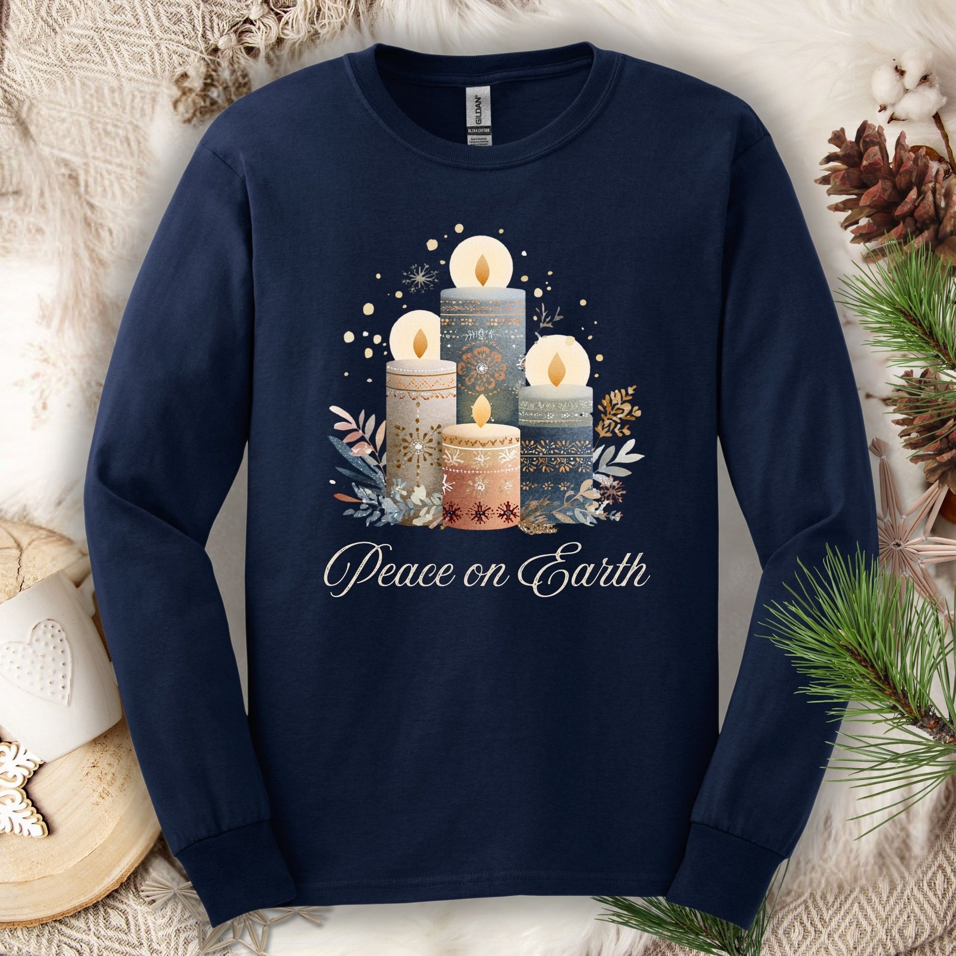 Navy long sleeve tee with folk art Nordic advent candles and "Peace on Earth" text.