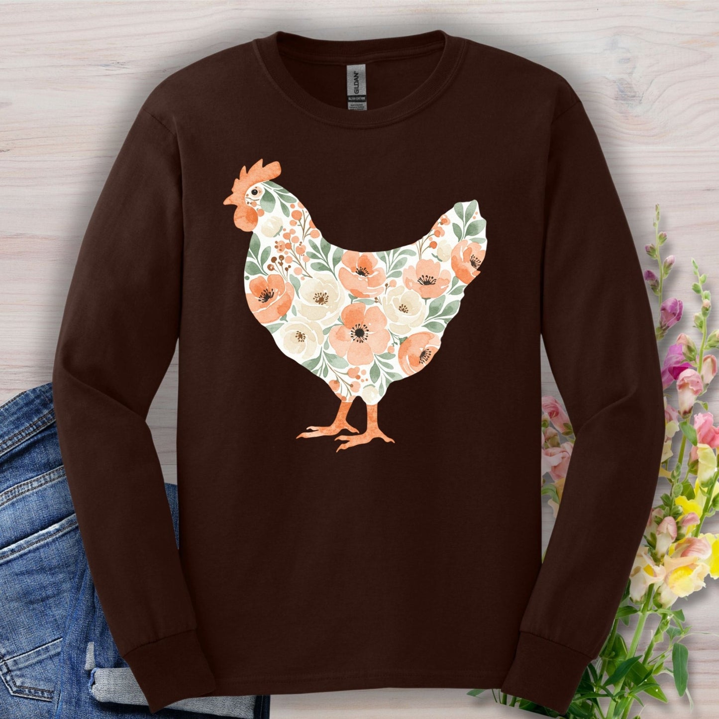 Dark Chocolate long sleeve tee with a watercolor floral hen design in peach, cream, and green.