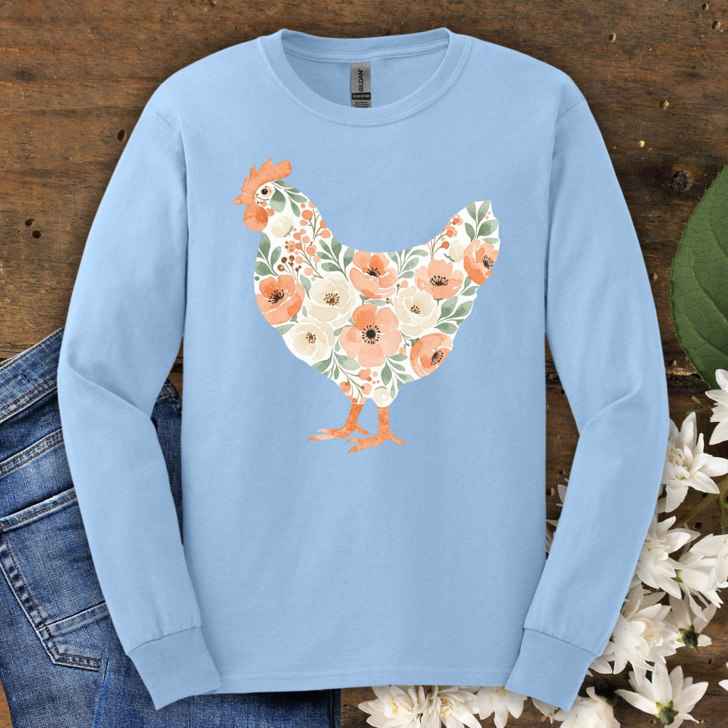 Light blue long sleeve tee with a watercolor floral hen design in peach, cream, and green.
