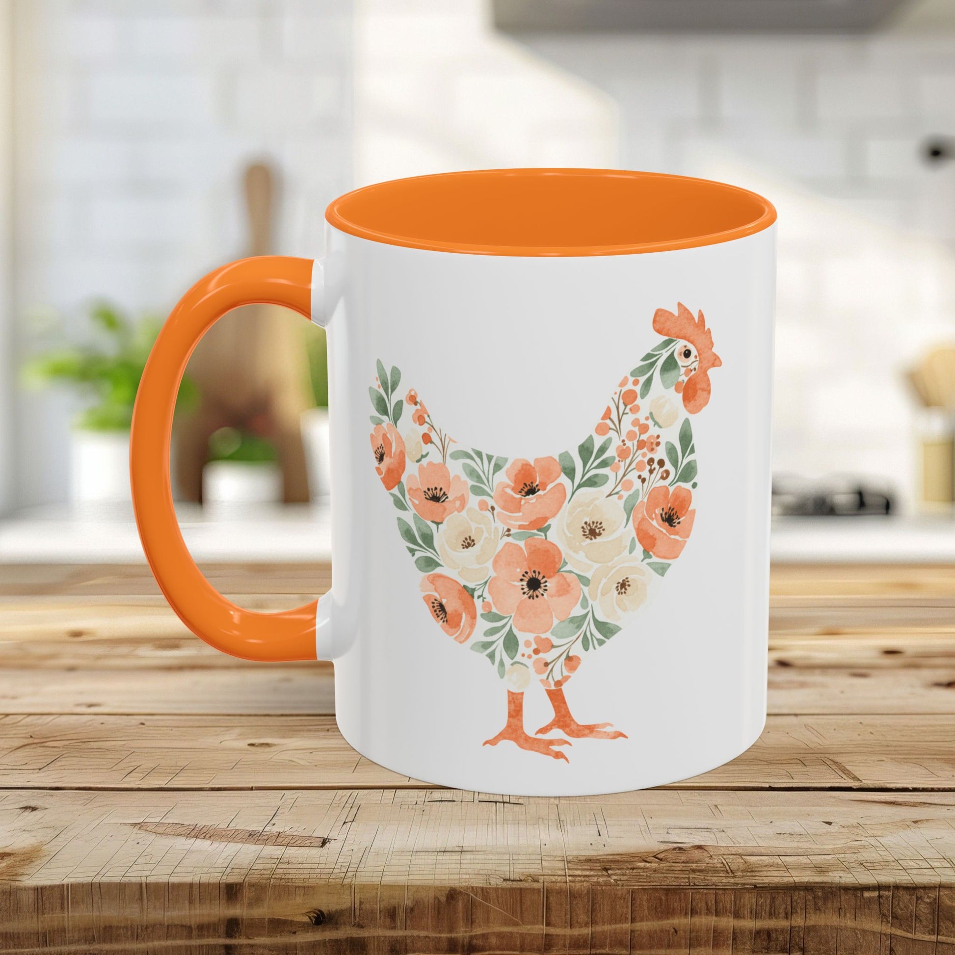 White ceramic mug with an orange handle and interior, featuring a floral chicken silhouette in coral and sage.