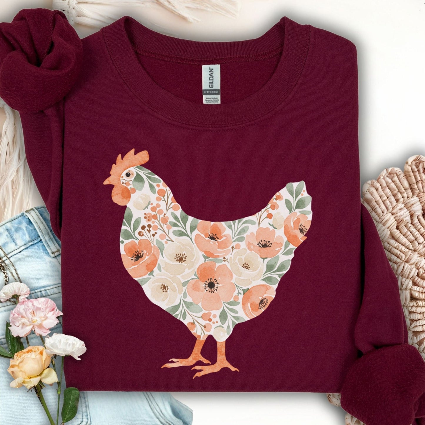 Maroon 50/50 cotton-poly sweatshirt with a floral hen design in peach, cream, and green.