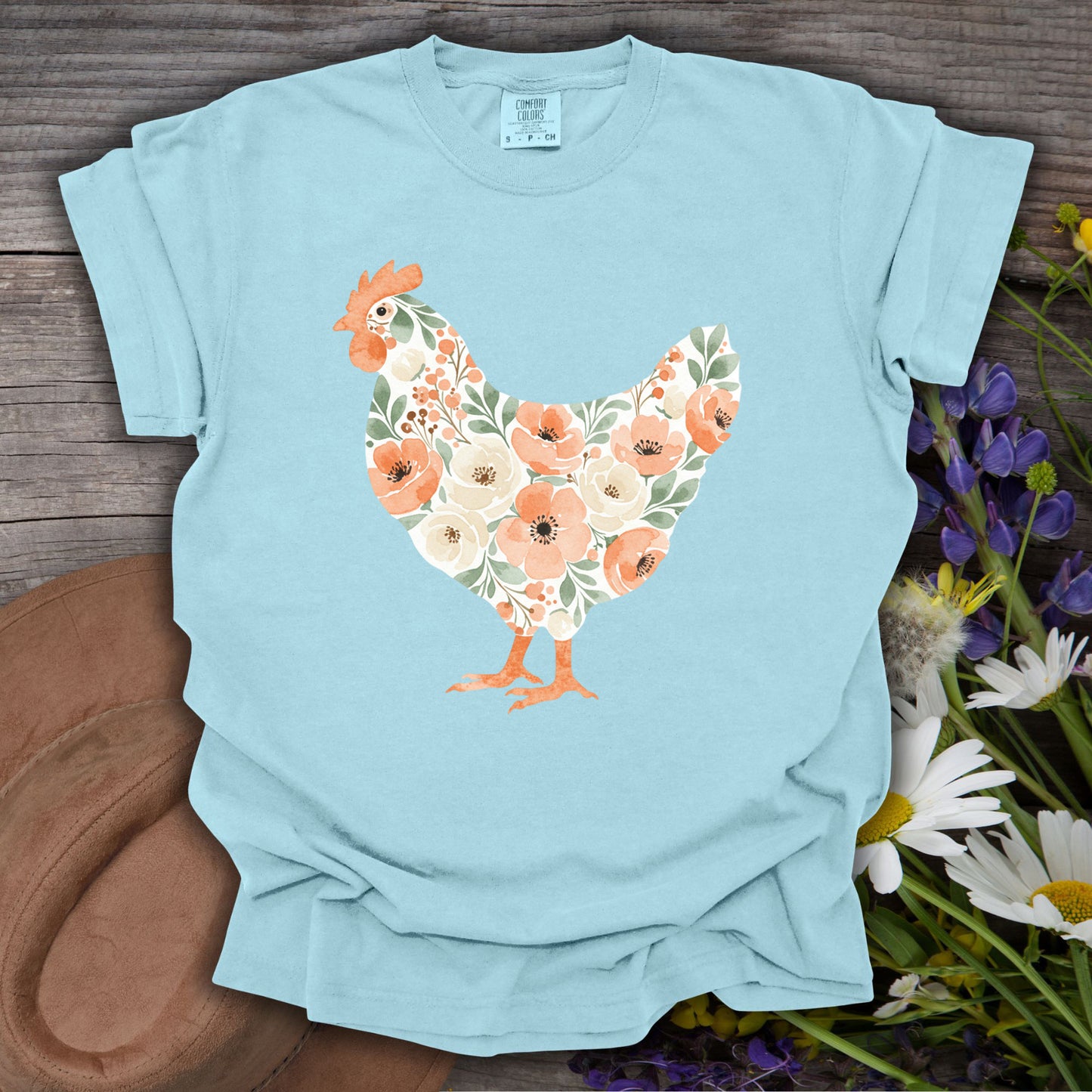 Chambray S t-shirt with a watercolor floral hen design in peach, cream, and green.