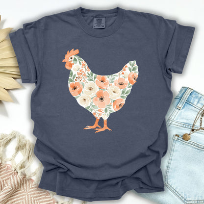 Denim S t-shirt with a watercolor floral hen design in peaches, cream, and green.
