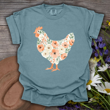 Ice Blue S t-shirt with a watercolor floral hen design featuring peach and cream flowers.