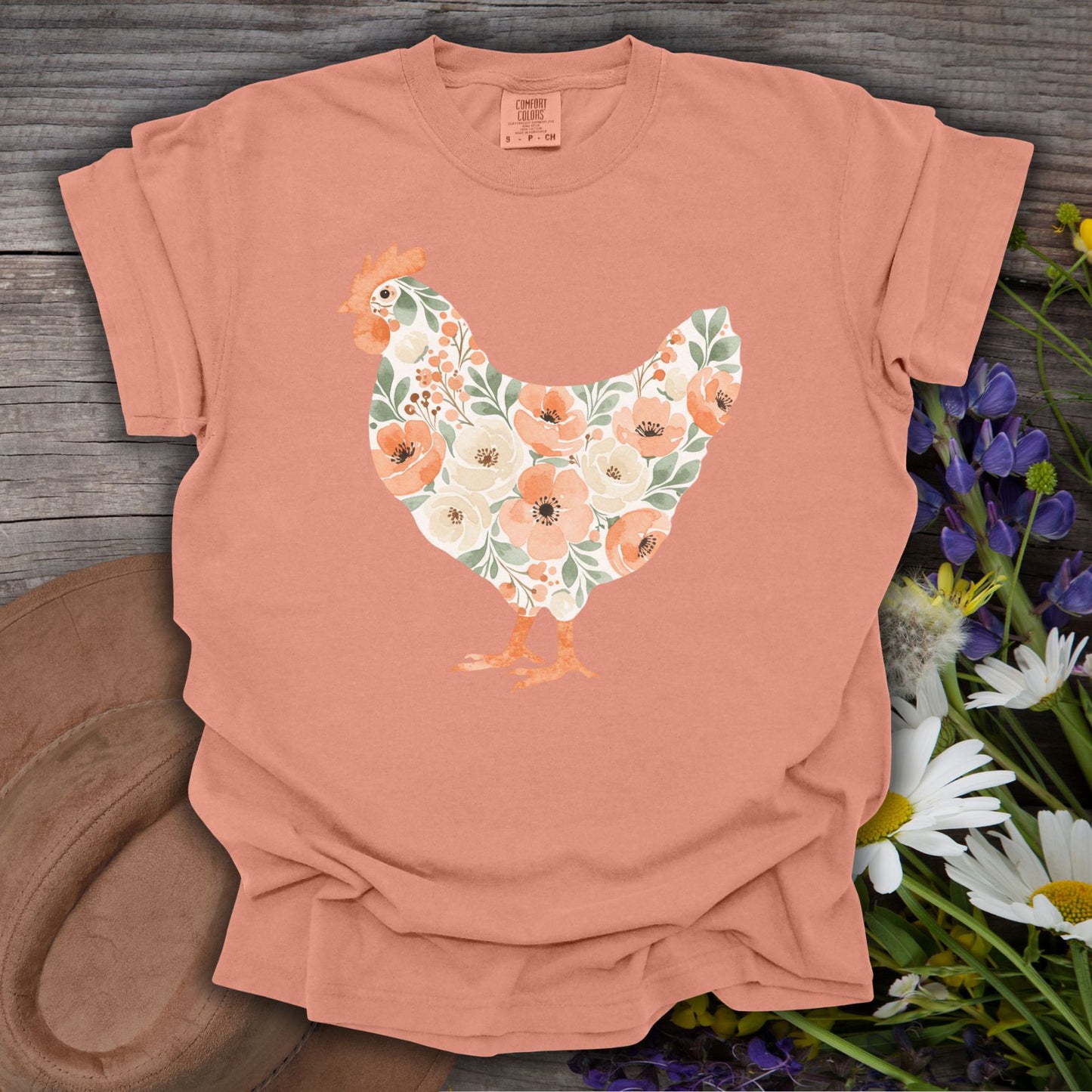 Terracotta S t-shirt with a watercolor floral hen design, featuring peach, cream, and green flowers.