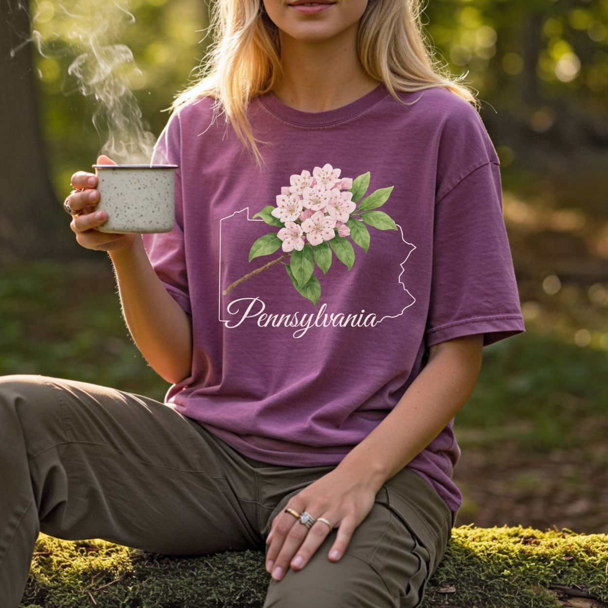 Garment-dyed plum t-shirt with a Pennsylvania outline, pink mountain laurel, and "Pennsylvania" text.