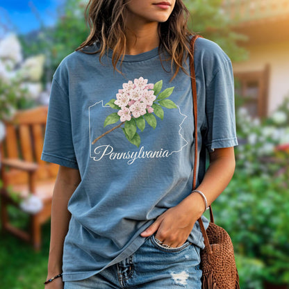 Relaxed-fit, garment-dyed blue t-shirt with pink mountain laurel blooms over a Pennsylvania outline.