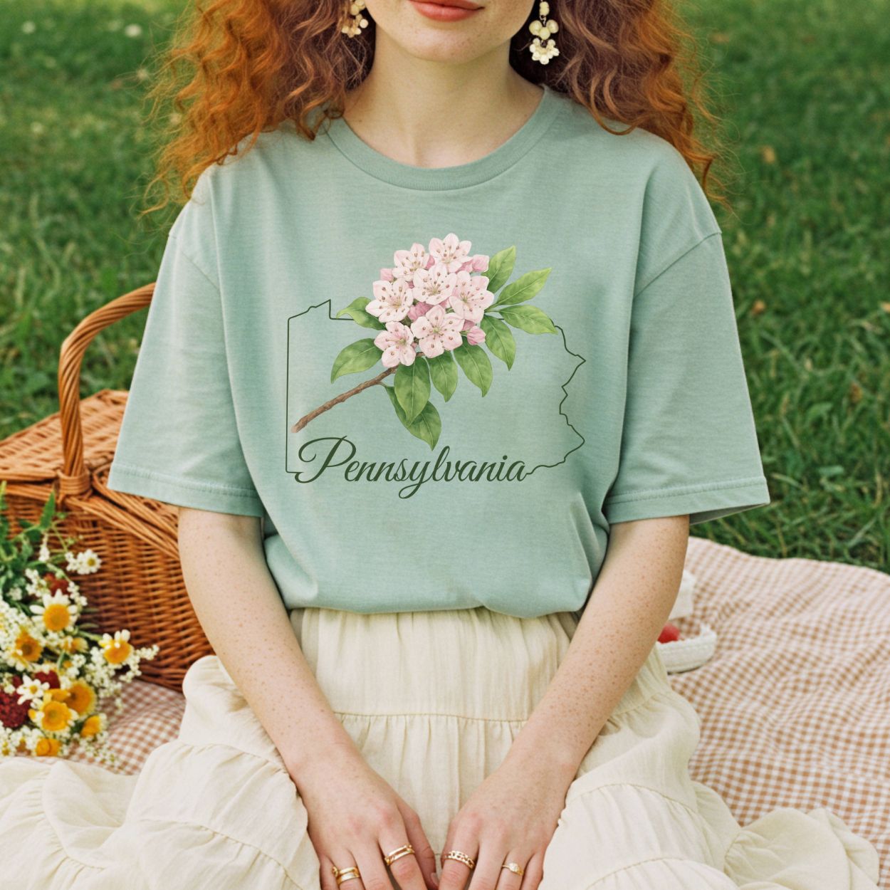 Relaxed-fit, garment-dyed sage green t-shirt with pink mountain laurel over a Pennsylvania outline.