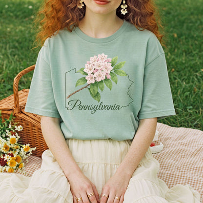 Relaxed-fit, garment-dyed sage green t-shirt with pink mountain laurel over a Pennsylvania outline.