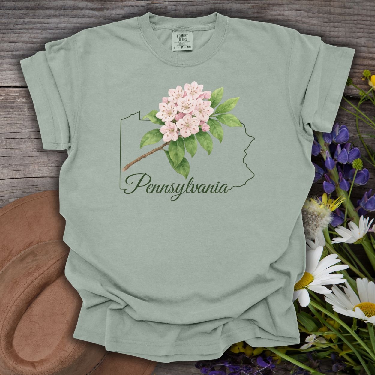 Bay green garment-dyed cotton t-shirt with a pink mountain laurel and Pennsylvania outline design.