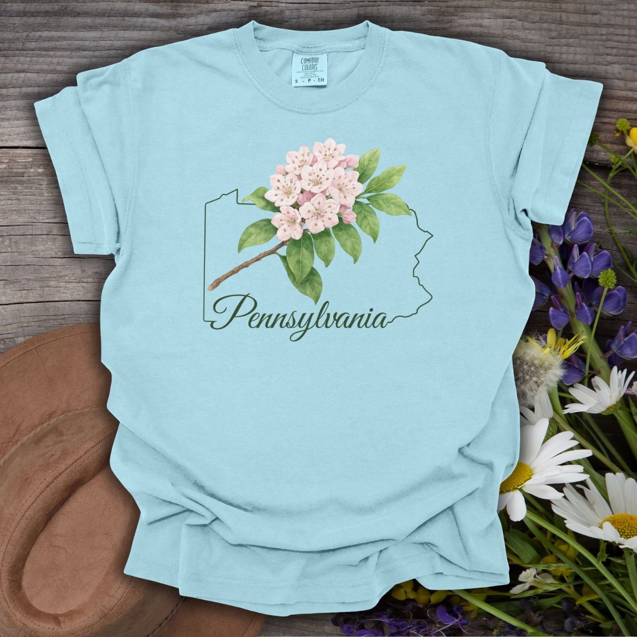 Chambray blue garment-dyed t-shirt with a pink mountain laurel bloom over a Pennsylvania outline.
