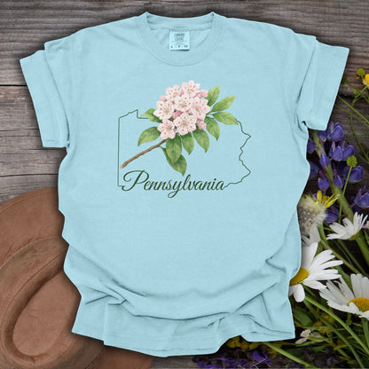 Chambray blue garment-dyed t-shirt with a pink mountain laurel bloom over a Pennsylvania outline.