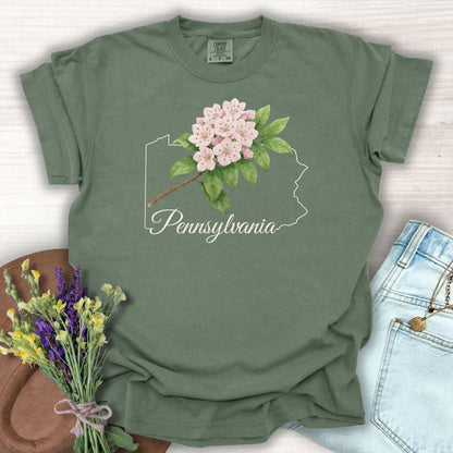 Moss green garment-dyed t-shirt with pink mountain laurel over a Pennsylvania outline.