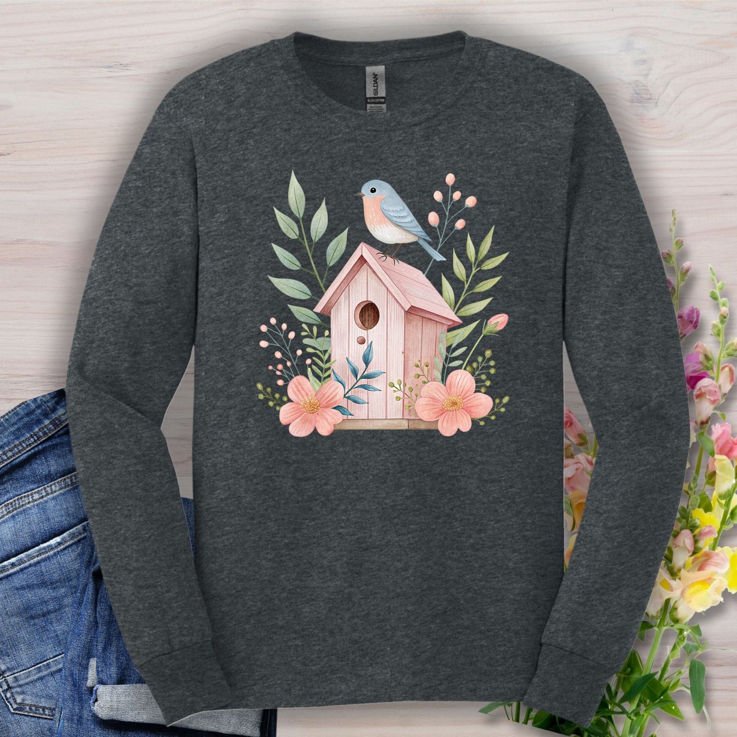 Dark Heather long sleeve tee with a pink birdhouse, blue bird, and floral watercolor design.