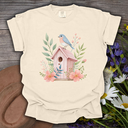 Ivory S t-shirt with a watercolor pink birdhouse, blue bird, and floral design.