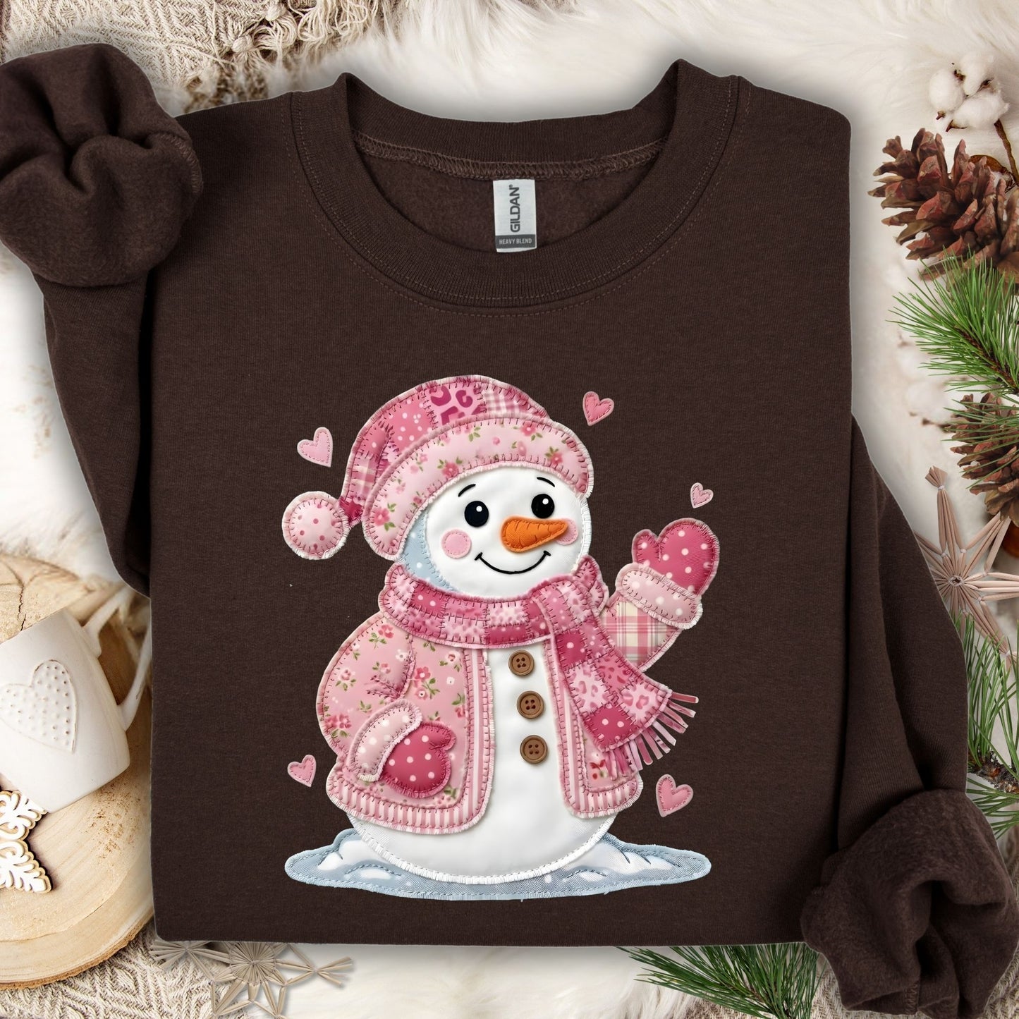 Dark chocolate heavy blend sweatshirt with a pink patchwork snowman and hearts design.