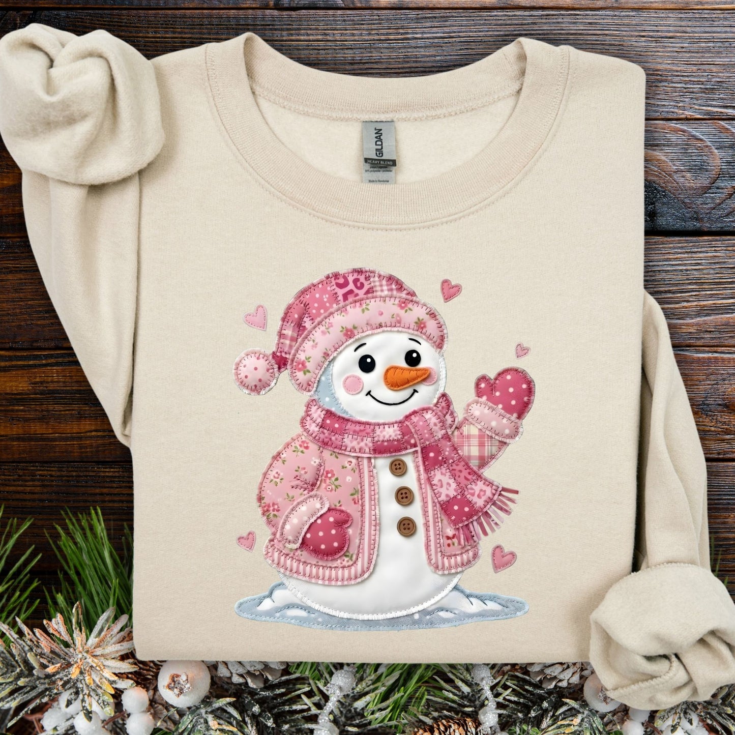 Sand heavy blend sweatshirt with a pink faux patchwork Valentine's snowman design.
