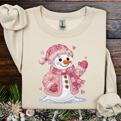 Sand heavy blend sweatshirt with a pink faux patchwork Valentine's snowman design.