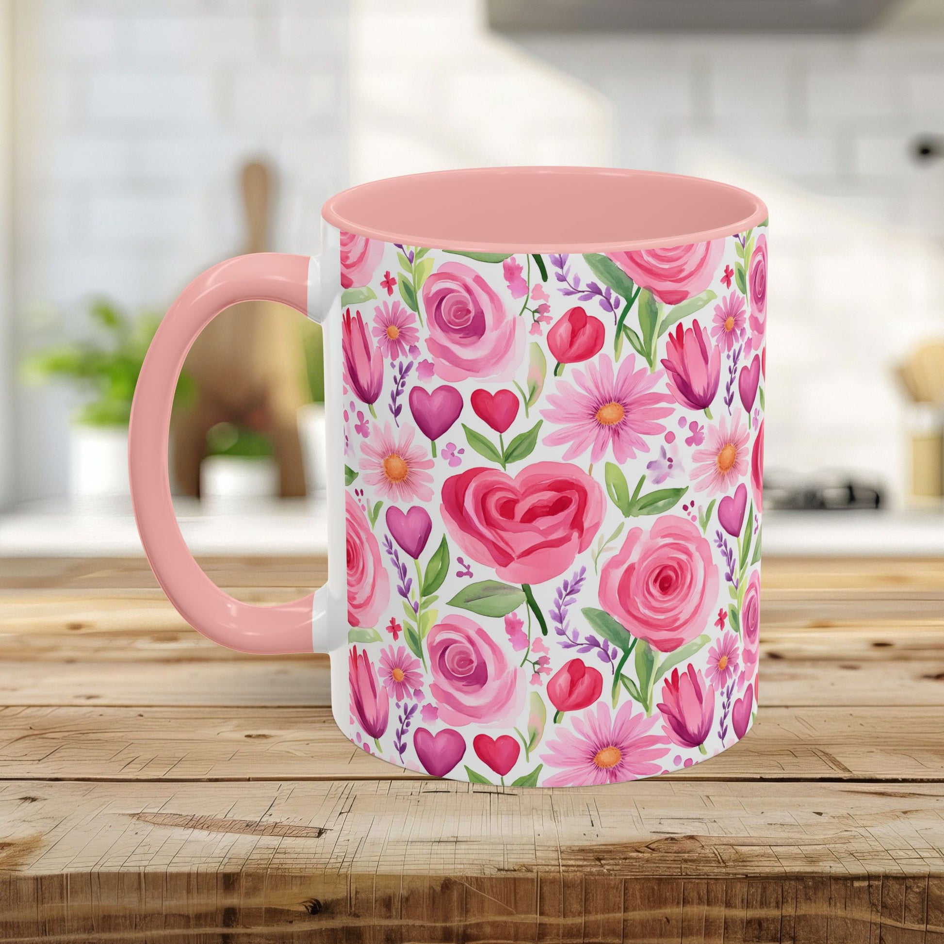 Pink ceramic mug with a blush interior and handle, featuring a watercolor print of roses, tulips, daisies, and hearts.
