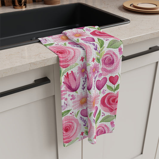 Pink rose, tulip, and heart watercolor microfiber kitchen towel draped over a light countertop.