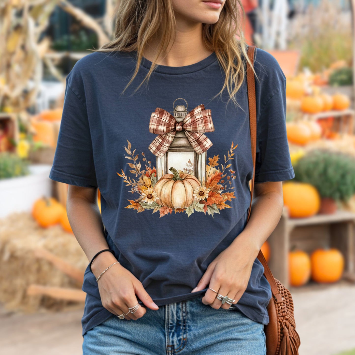 Navy garment-dyed tee with a rustic lantern, plaid bow, pumpkin, and autumn leaves design.
