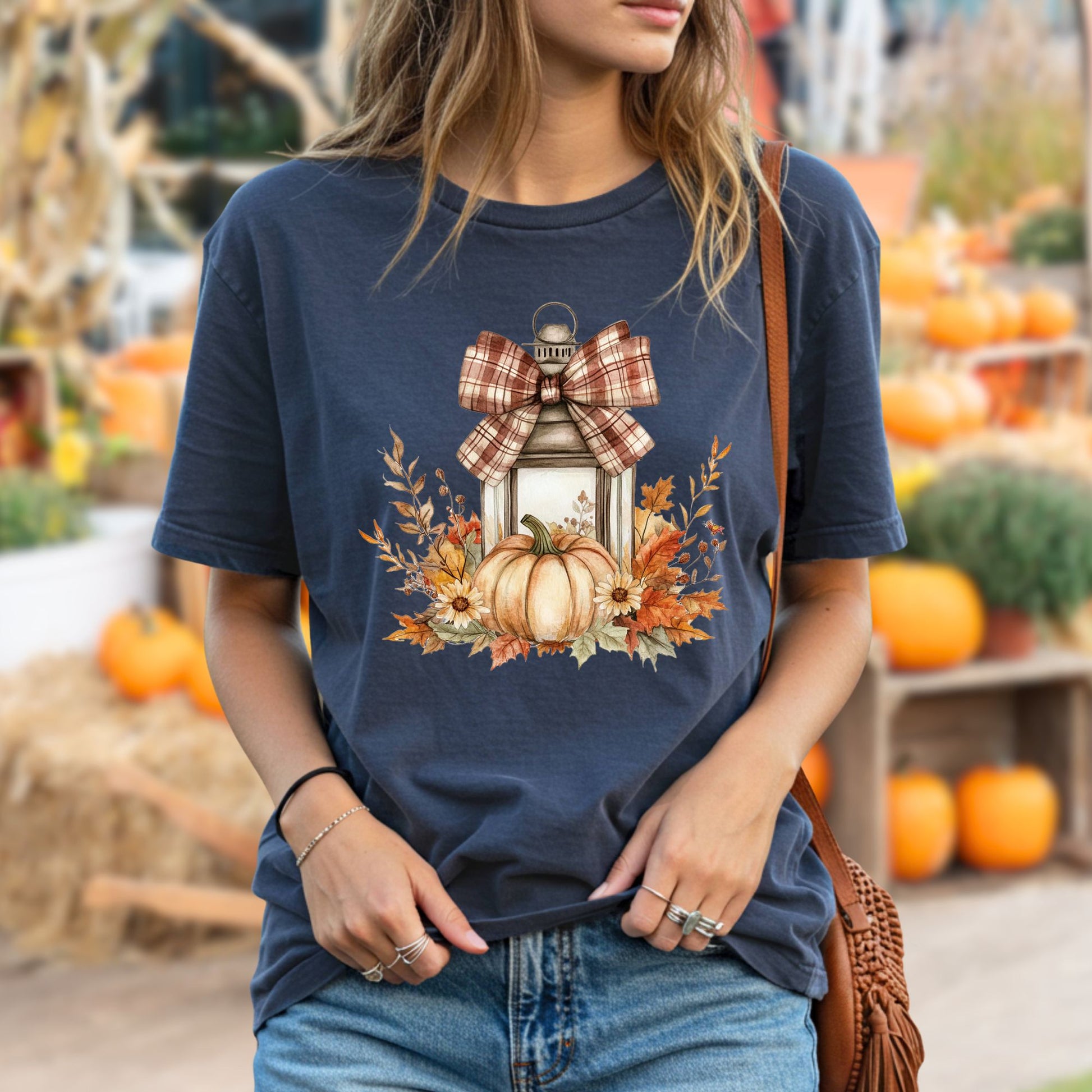 Navy garment-dyed tee with a rustic lantern, plaid bow, pumpkin, and autumn leaves design.
