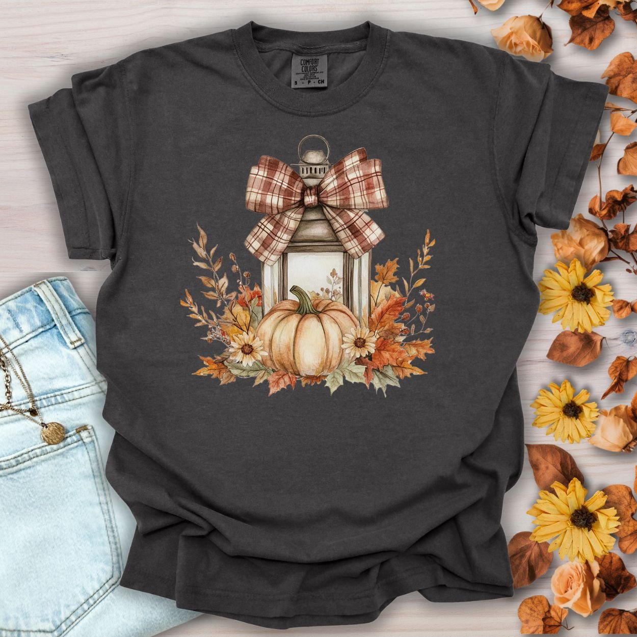 Pepper S tee with a rustic autumn lantern, pumpkin, sunflowers, and plaid bow design.