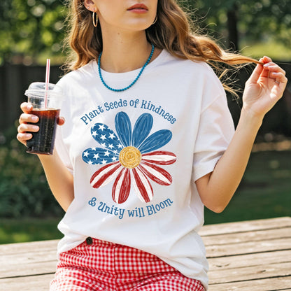 White Plant Seeds of Kindness USA T-shirt with a watercolor American flag daisy design.