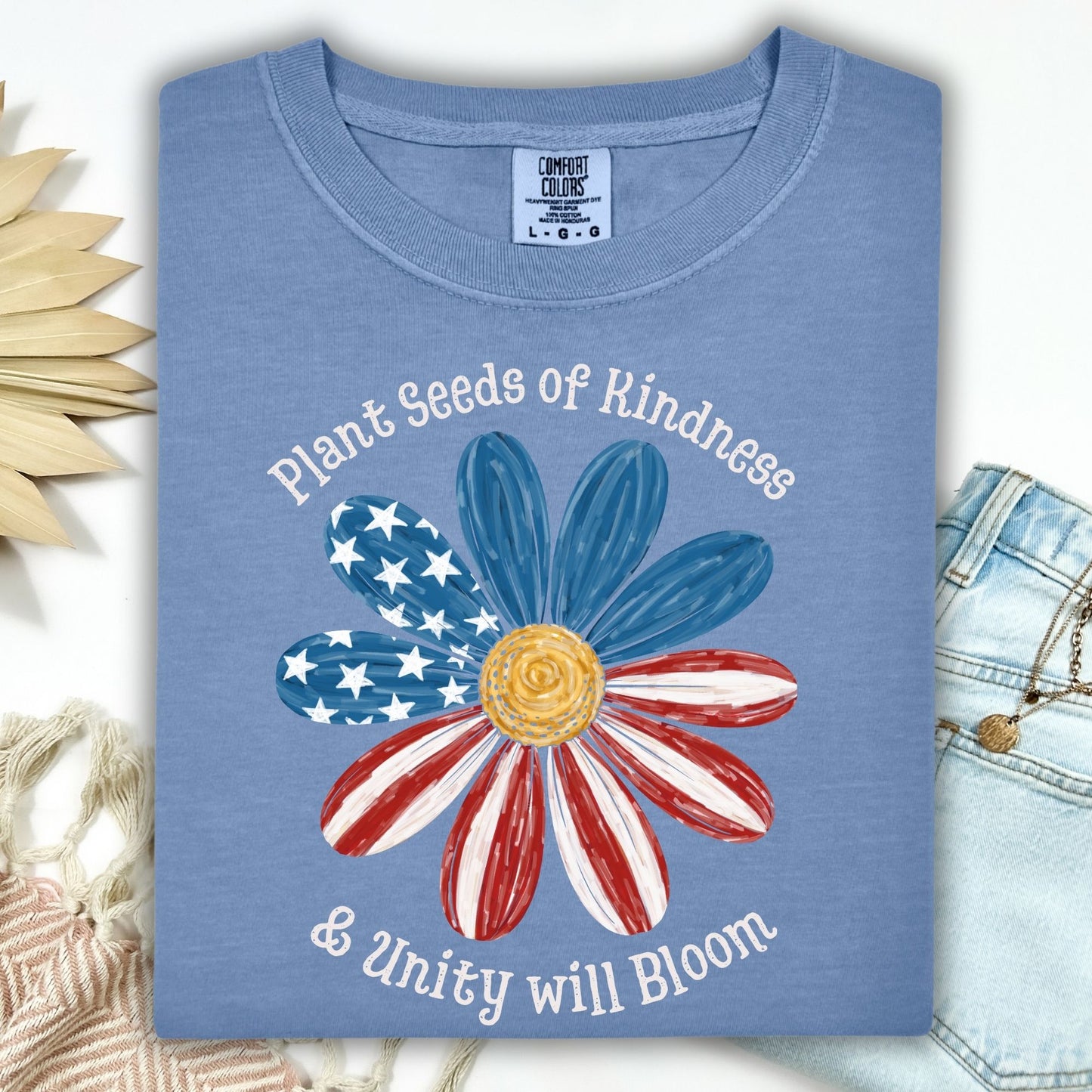 Blue Jean t-shirt with "Plant Seeds of Kindness & Unity will Bloom" and a watercolor American flag daisy.