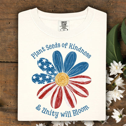 Ivory Comfort Colors t-shirt with "Plant Seeds of Kindness & Unity will Bloom" and an American flag daisy.