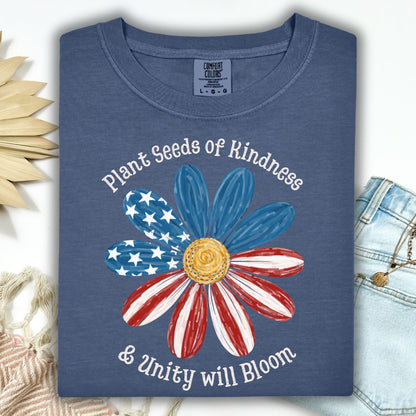 Denim Comfort Colors t-shirt with "Plant Seeds of Kindness & Unity will Bloom" and a watercolor American flag daisy.