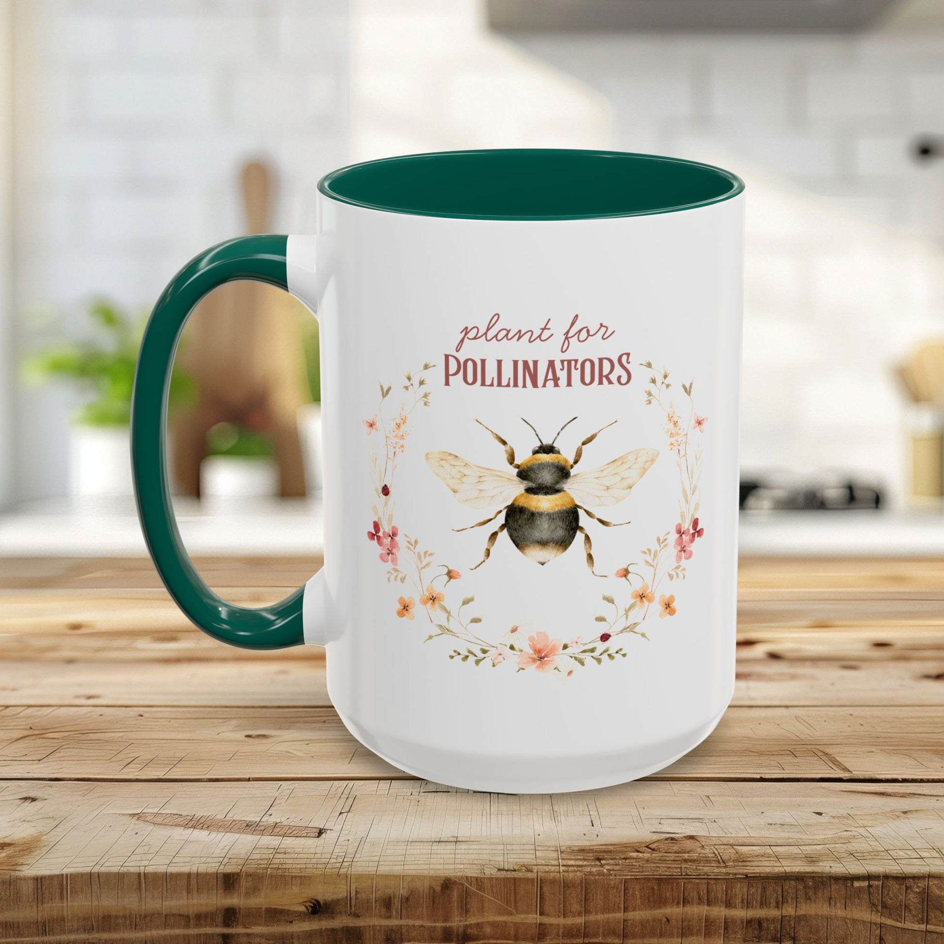 White ceramic mug with green handle and interior, featuring a watercolor bee and "plant for pollinators" text.